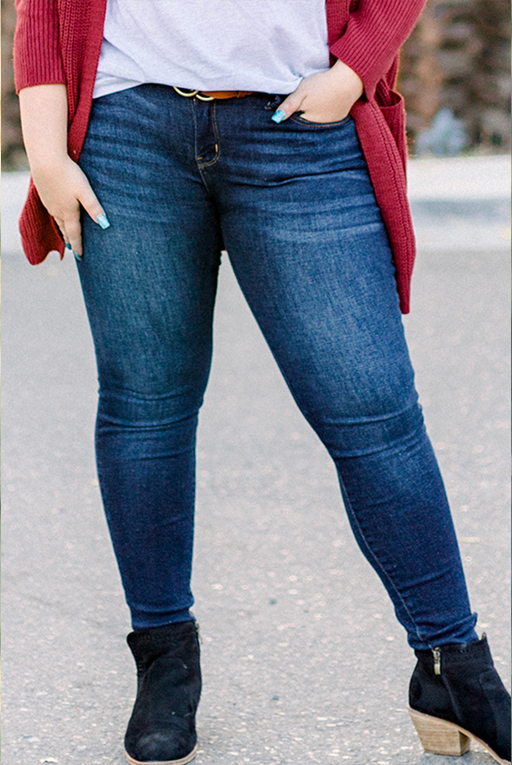 Shop Bottoms | Women featured wearing dark wash denim jeans with black ankle booties, a red cardigan and white top | Timber Brooke Boutique is a women's fashion boutique located in Amarillo, Texas